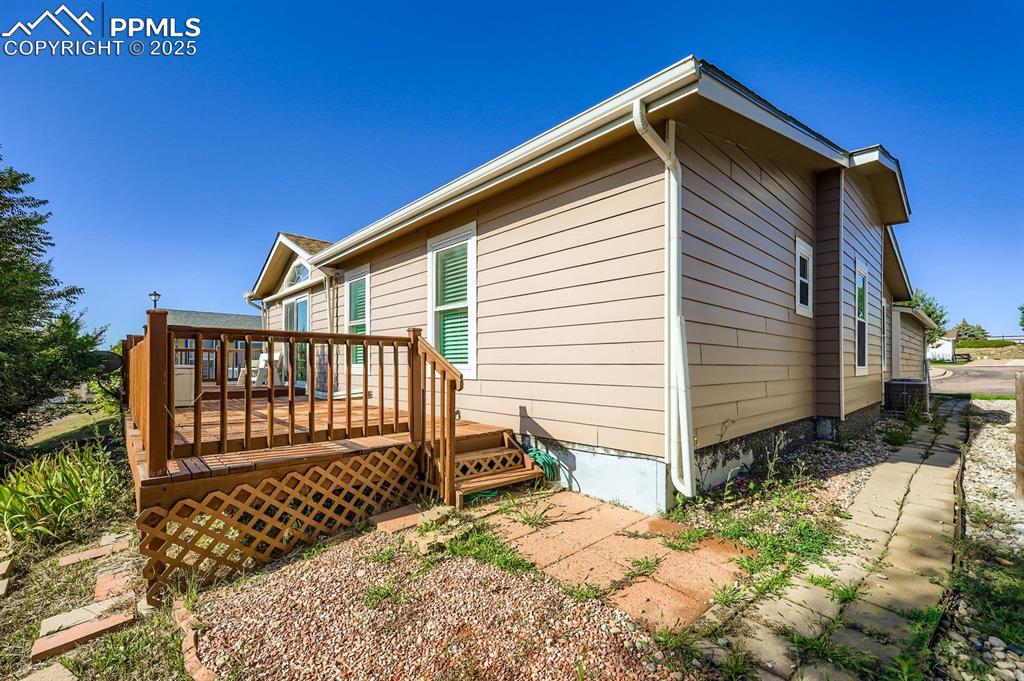 Image 29 of 29: View of side of property with a deck