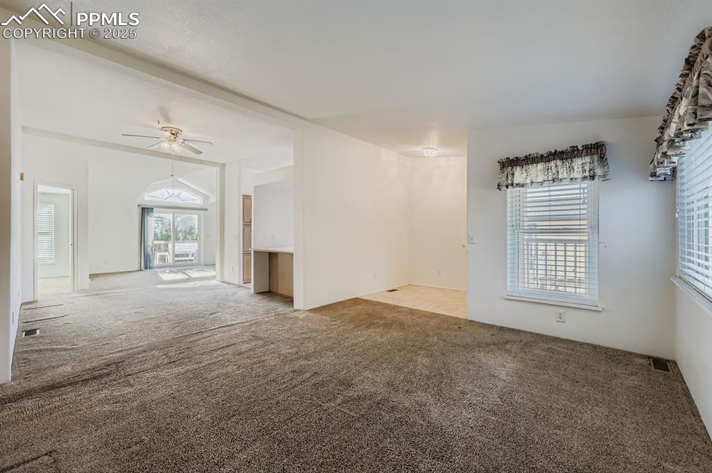 Image 7 of 29: Carpeted empty room featuring ceiling fan