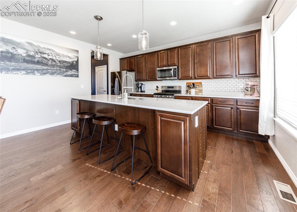 Image 10 of 43: Engineered hardwood floors make clean up in the kitchen a breeze!