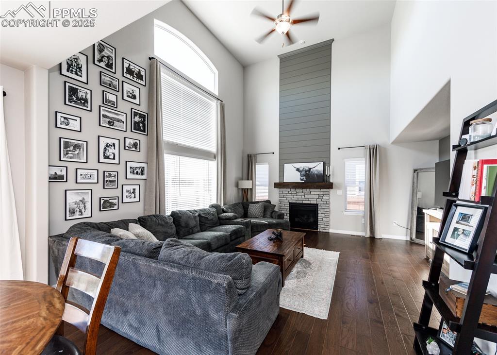 Image 14 of 43: Majestic and contemporary fireplace anchors this great room. Windows let in