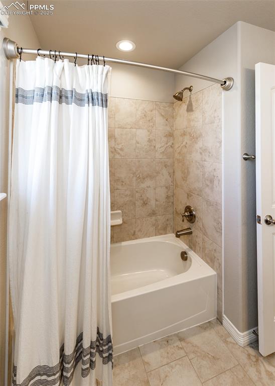 Image 27 of 43: Tub/shower in full main bathroom upstairs.