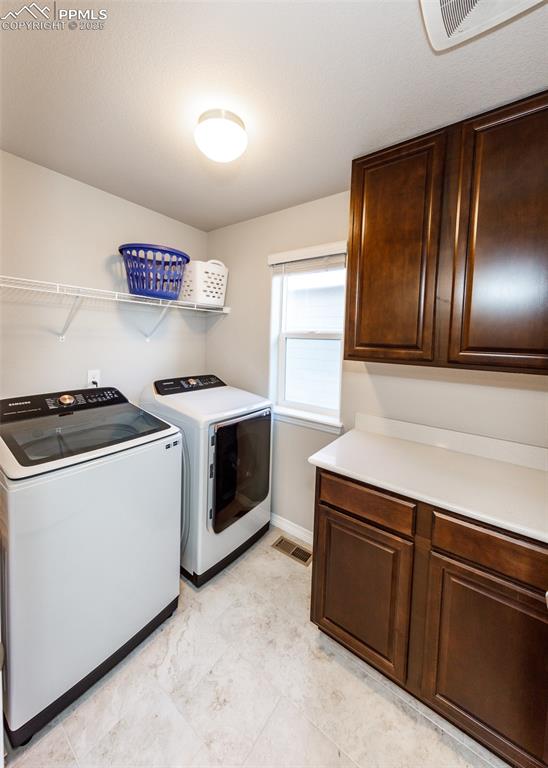 Image 31 of 43: Convenient laundry area with cabinets upstairs.