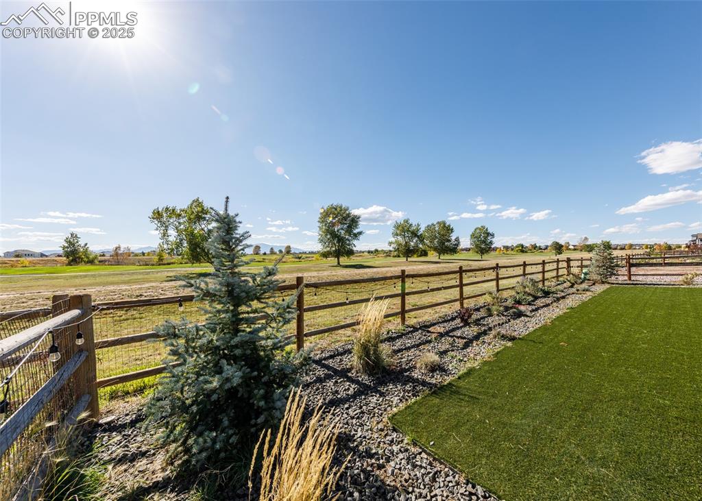 Image 40 of 43: Enjoy the luxury of open space and views of the golf course from the back o