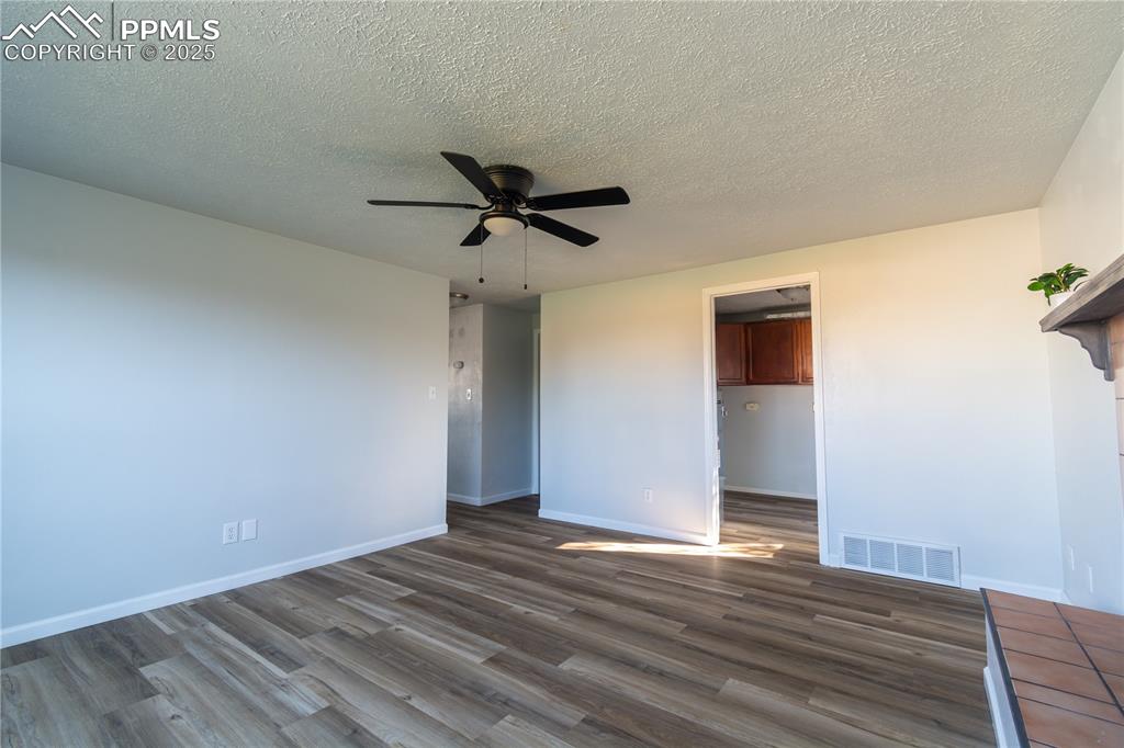 Image 19 of 37: Unfurnished bedroom with  wood-type flooring, a textured ceiling, a ceiling
