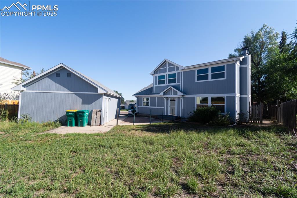 Image 2 of 37: Rear view of property featuring an outbuilding