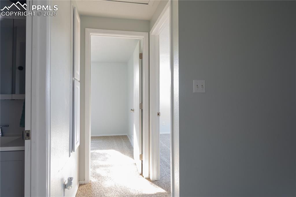 Image 30 of 37: Corridor with light colored carpet and baseboards