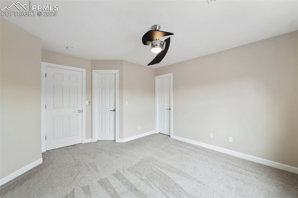 Image 32 of 50: Unfurnished bedroom with baseboards, ceiling fan, and carpet flooring