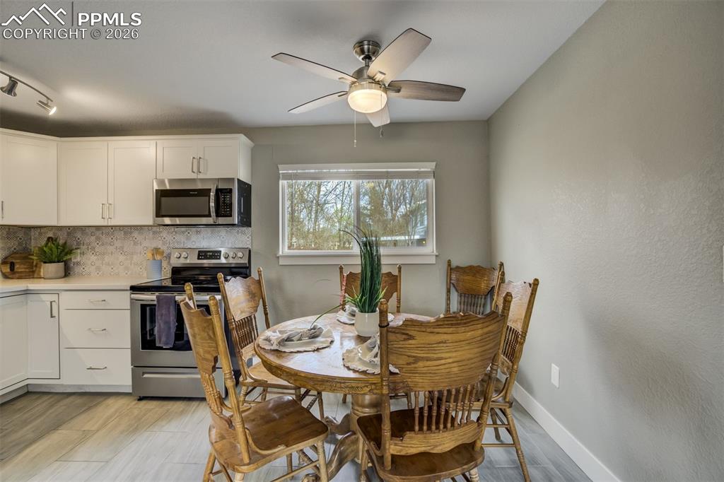 Image 8 of 29: Dining area featuring ceiling fan and light wood-style floors