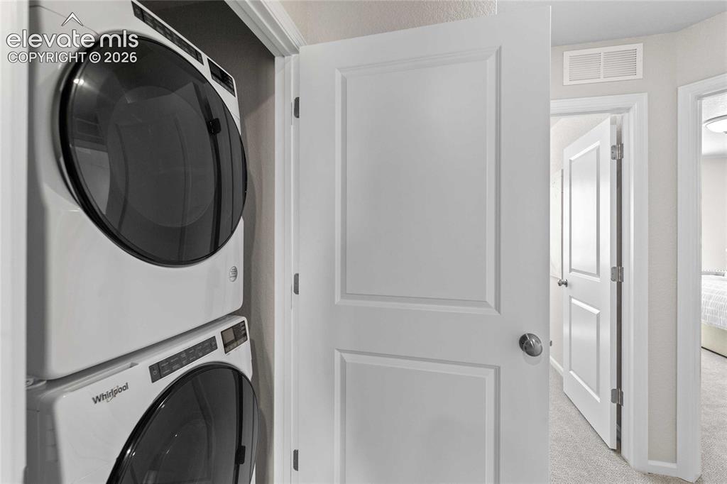 Image 13 of 25: Stackable washer and dryer appliances within a dedicated closet
*Photos of