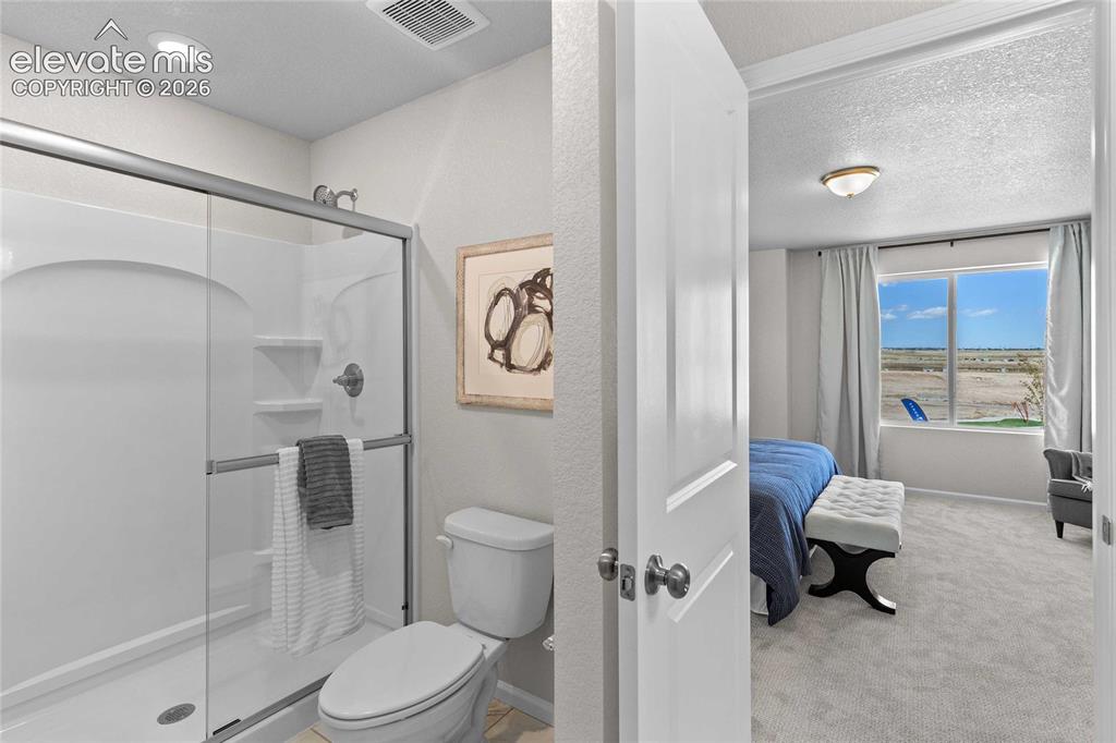 Image 15 of 25: White shower enclosure with clear glass sliding doors and brushed nickel fi