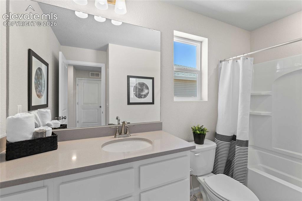Image 19 of 25: Spa-inspired bathroom featuring a large framed mirror, dual-sink vanity wit