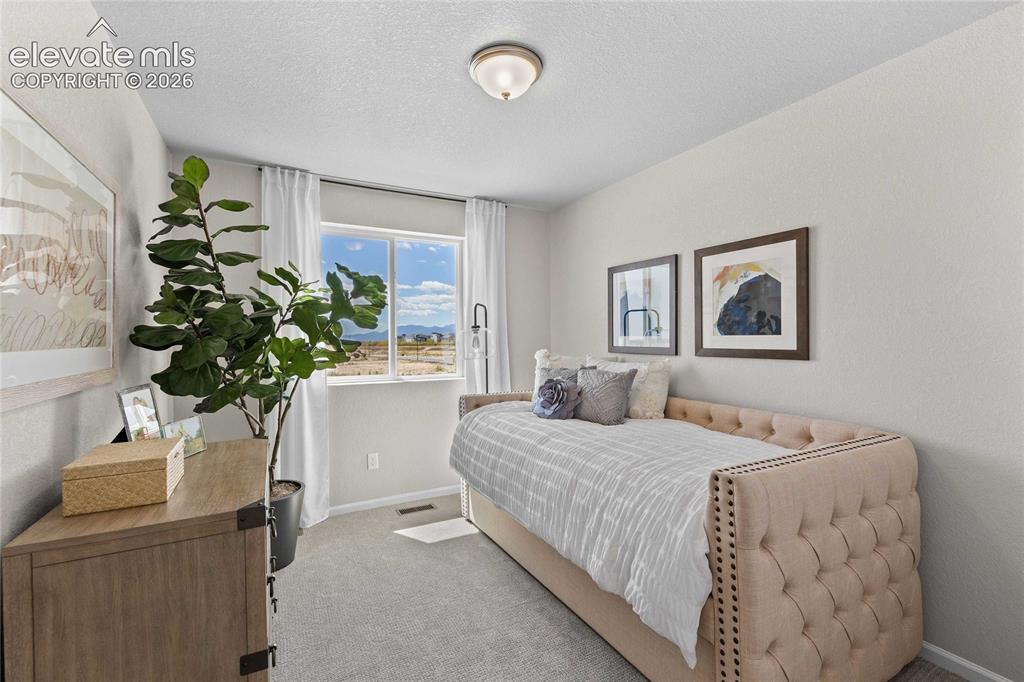 Image 21 of 25: Carpeted room featuring a double-pane window, flush mount lighting, and lig
