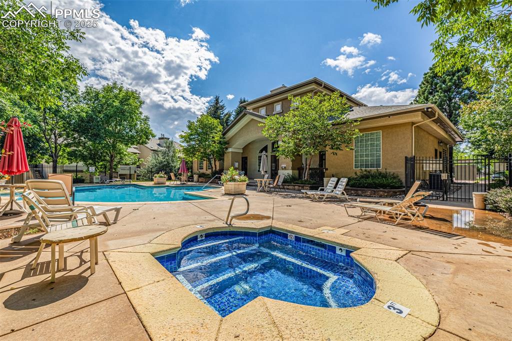 Image 18 of 24: Community pool with a hot tub