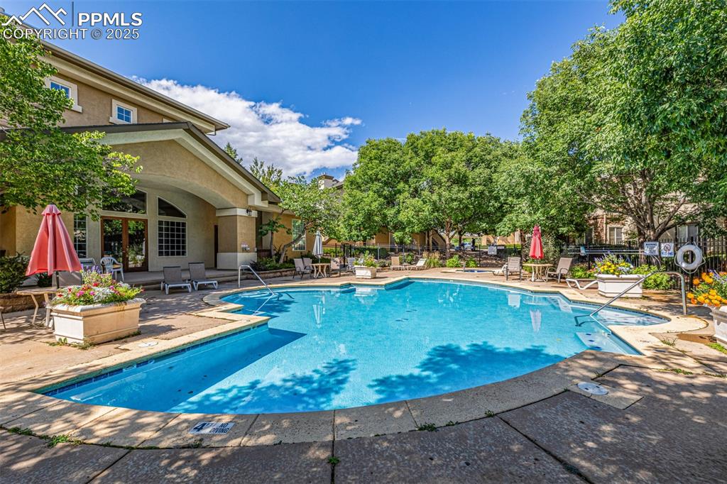 Image 19 of 24: Community pool featuring a patio area