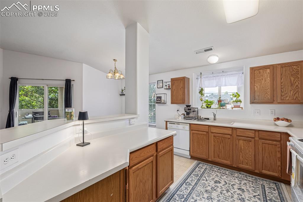 Image 7 of 24: Kitchen featuring light countertops 
