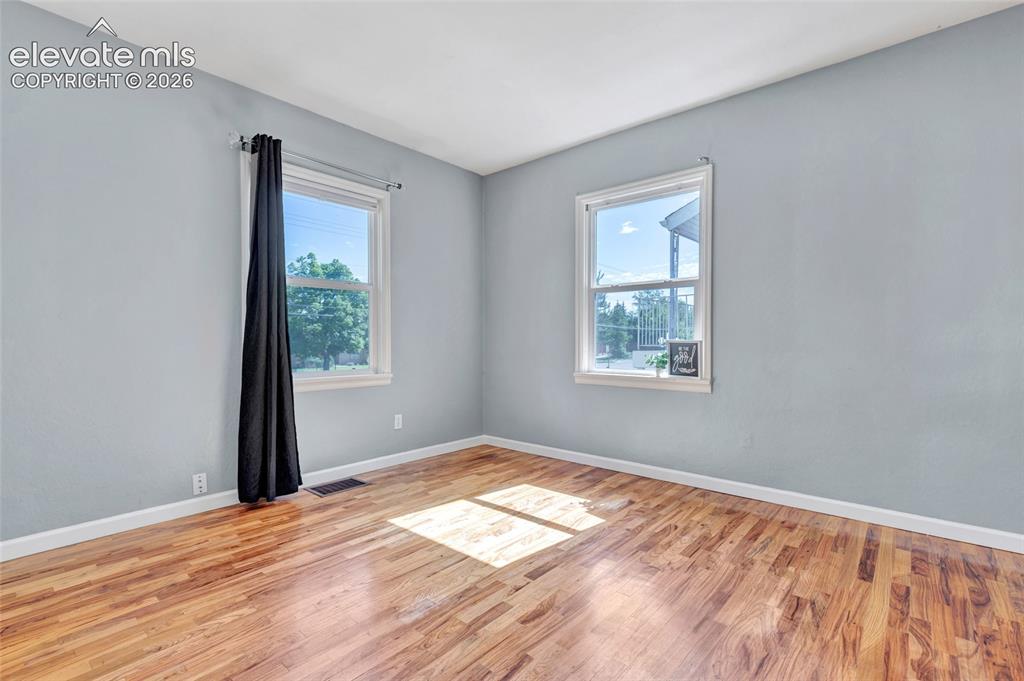 Image 16 of 39: Wood flooring, 6-panel doors, built-in closet system