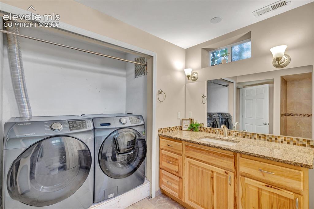 Image 33 of 39: Washer and Dryer will stay, located in the lower bath