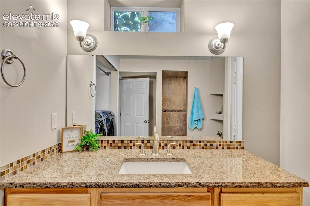 Image 34 of 39: 3/4 bath - Granite countertops, walk-in shower, built in shelving, linen cl