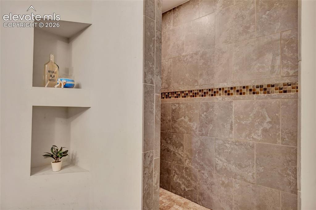 Image 35 of 39: 3/4 bath - Granite countertops, walk-in shower, built in shelving, linen cl