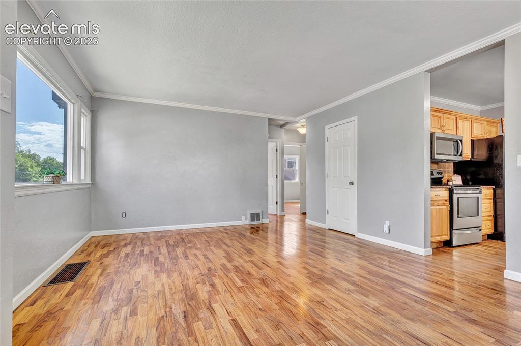 Image 8 of 39: Wood flooring, 6 panel doors, lots of natural light