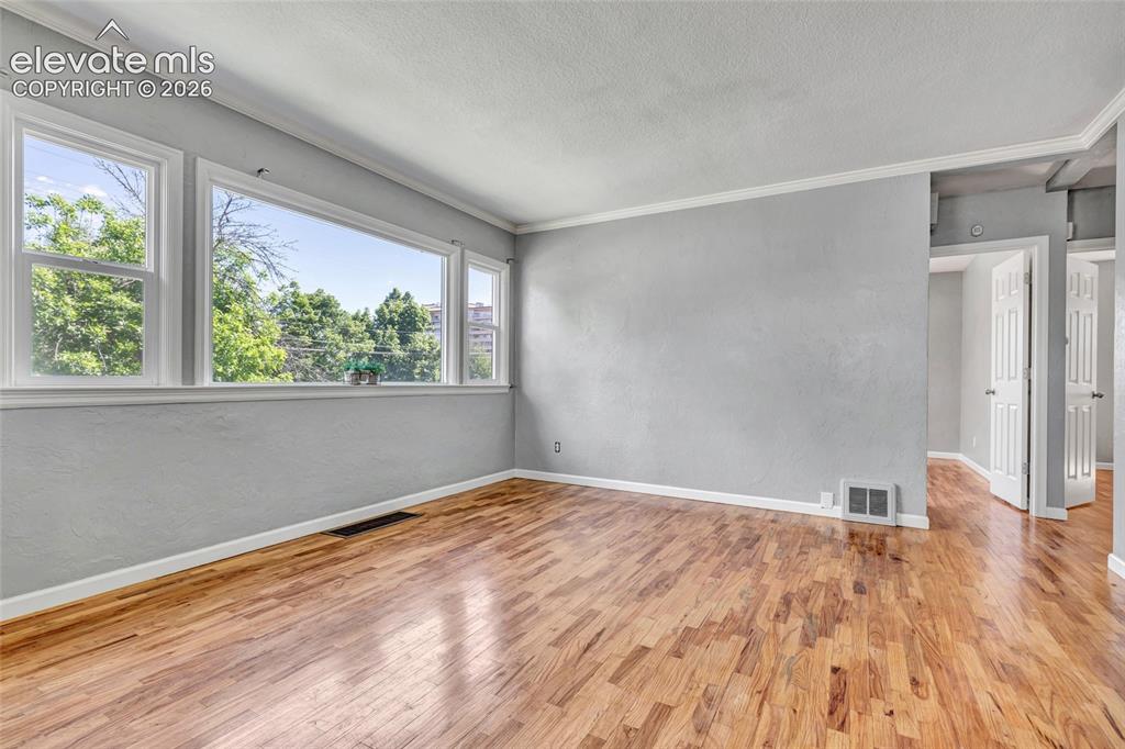 Image 9 of 39: Wood flooring, 6 panel doors, lots of natural light