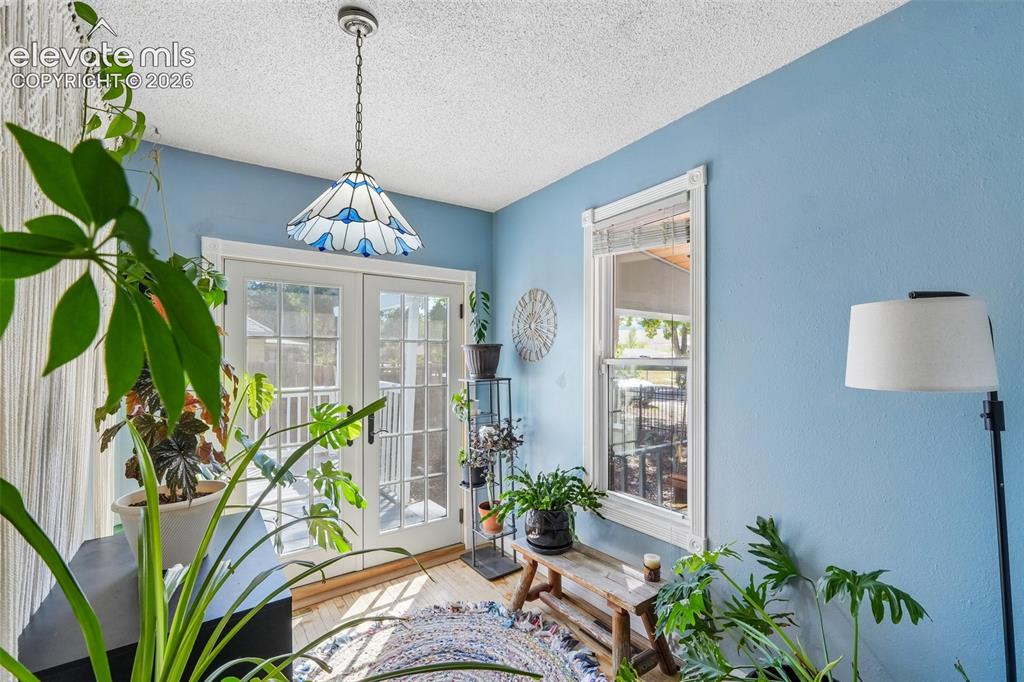 Image 10 of 43: Sun room with walk out to deck