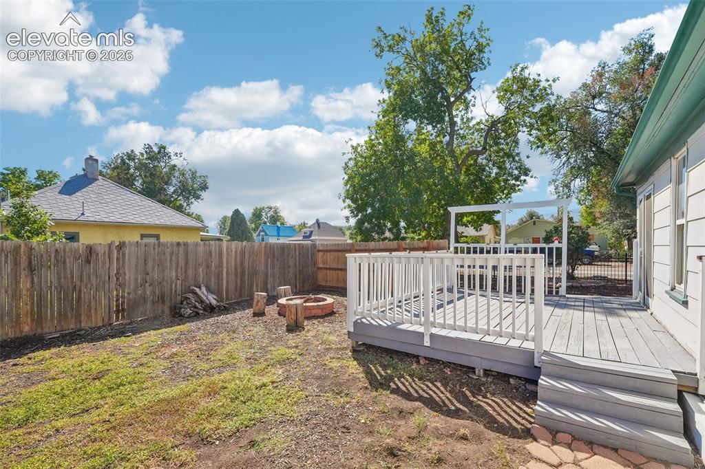 Image 15 of 43: Deck and yard off sunroom