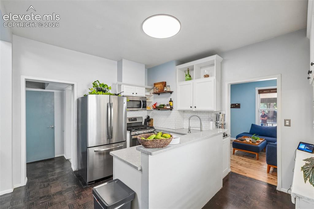 Image 16 of 43: Kitchen with stainless appliances and a gas range