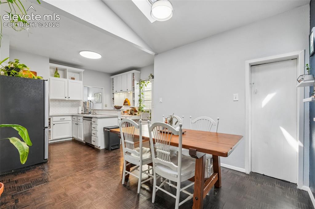 Image 19 of 43: Dining area with skylights