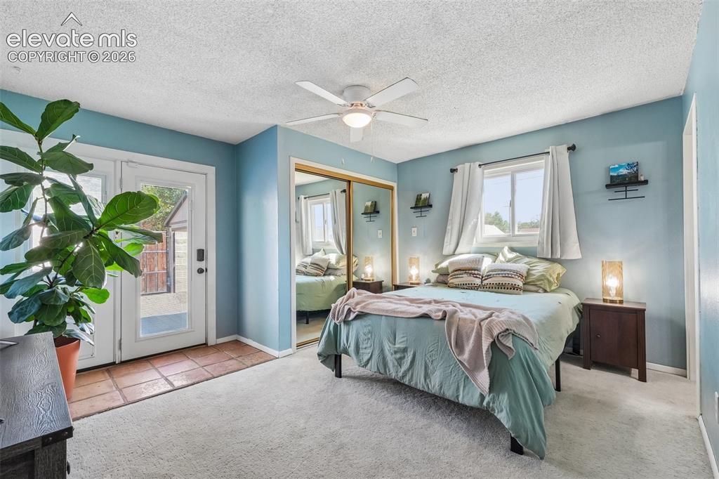 Image 22 of 43: Primary bedroom with 3/4 en suite and a walk out to private deck