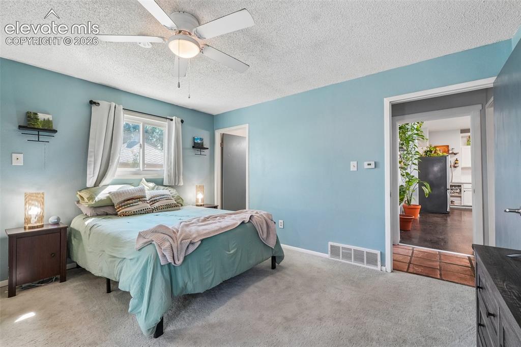 Image 23 of 43: Primary bedroom with 3/4 en suite and a walk out to private deck