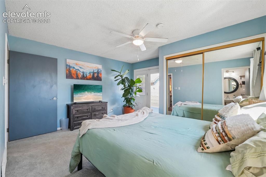 Image 25 of 43: Primary bedroom with 3/4 en suite and a walk out to private deck