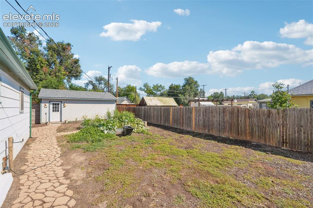 Image 36 of 43: Spacious backyard looking at detached garage