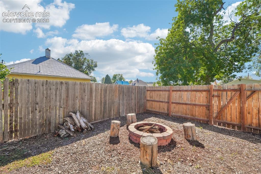 Image 37 of 43: Backyard with fire pit