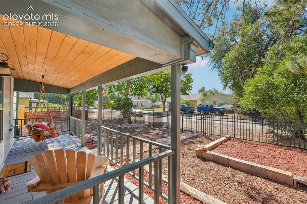 Image 4 of 43: Covered front porch and front yard