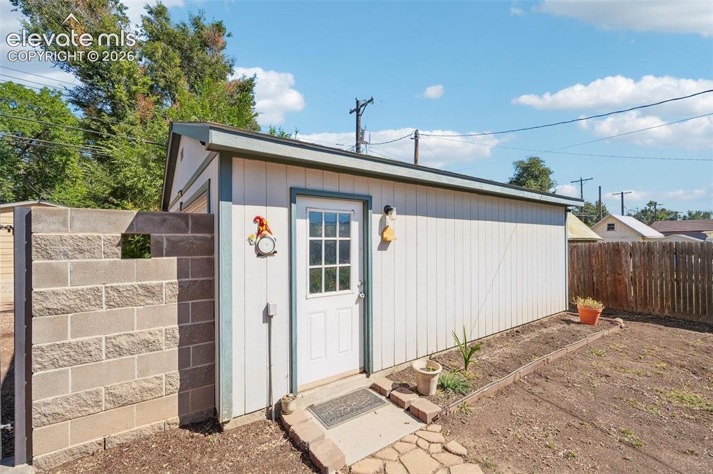 Image 40 of 43: Entry to garage from backyard