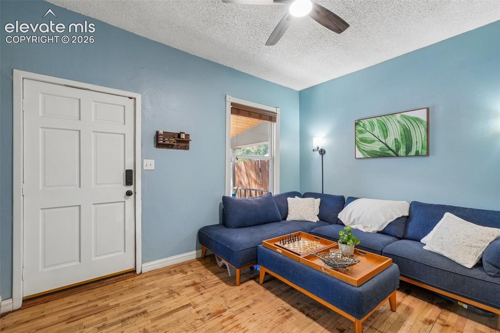 Image 7 of 43: Spacious living room with wood flooring