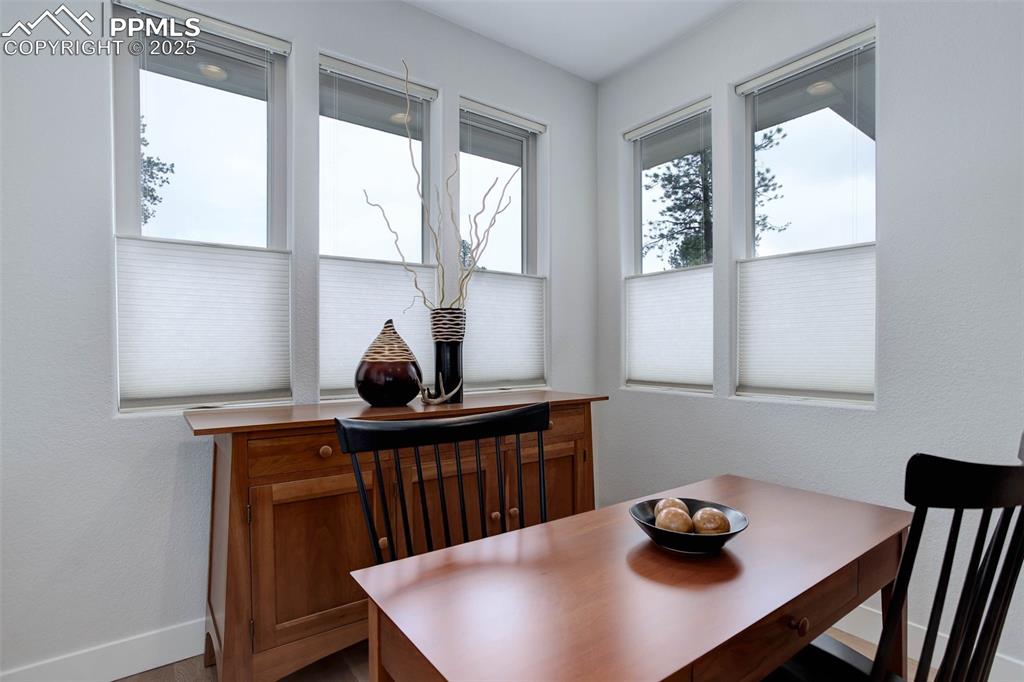 Image 13 of 32: Dining room featuring a textured wall and baseboards