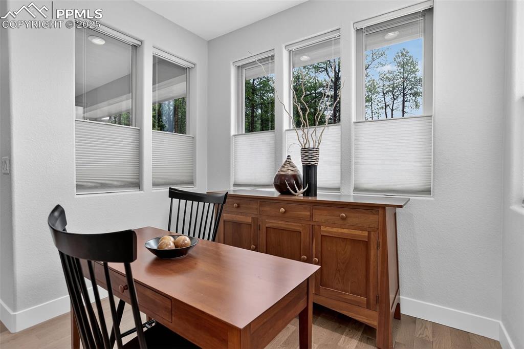Image 14 of 32: Dining room featuring light wood-style flooring, a textured wall, and plent