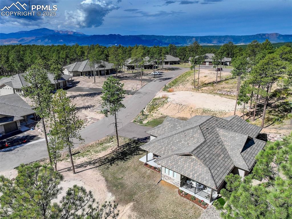 Image 6 of 32: Aerial perspective of suburban area featuring mountains