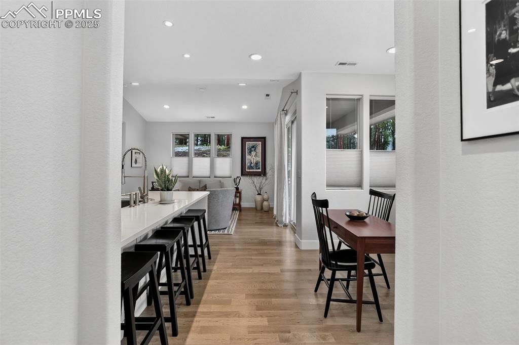 Image 9 of 32: Dining space featuring light wood finished floors, a textured wall, and rec