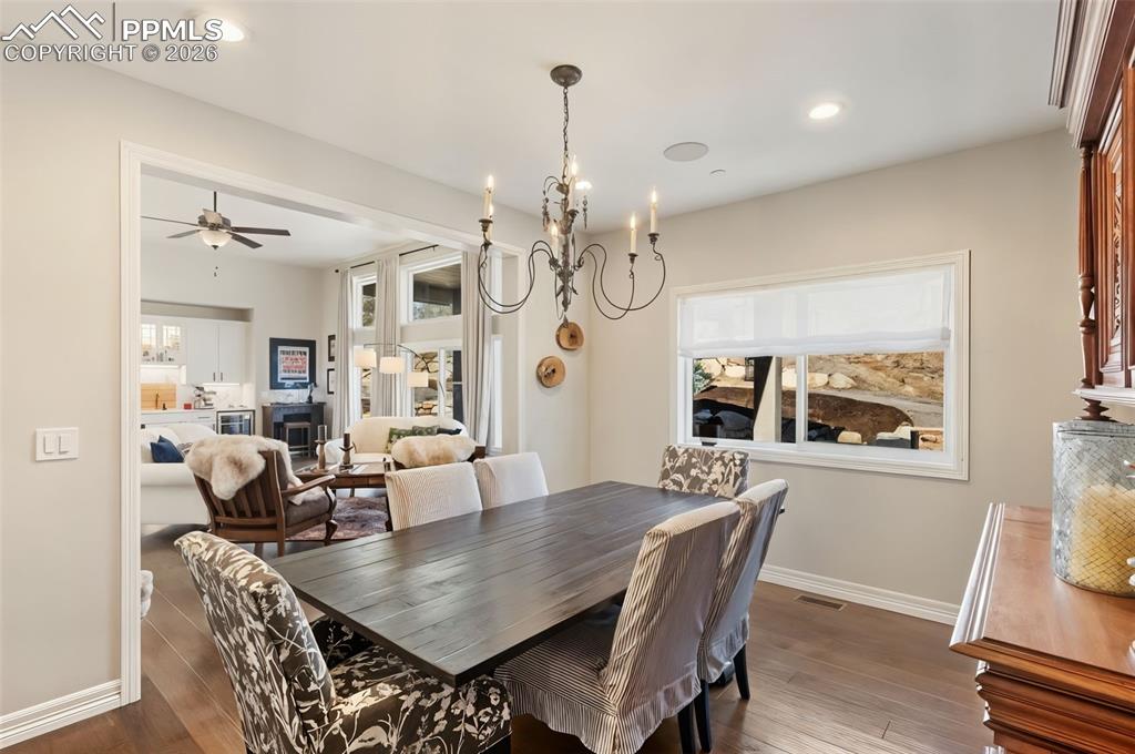 Image 10 of 49: The formal dining room acts as a transitional space, borrowing natural ligh