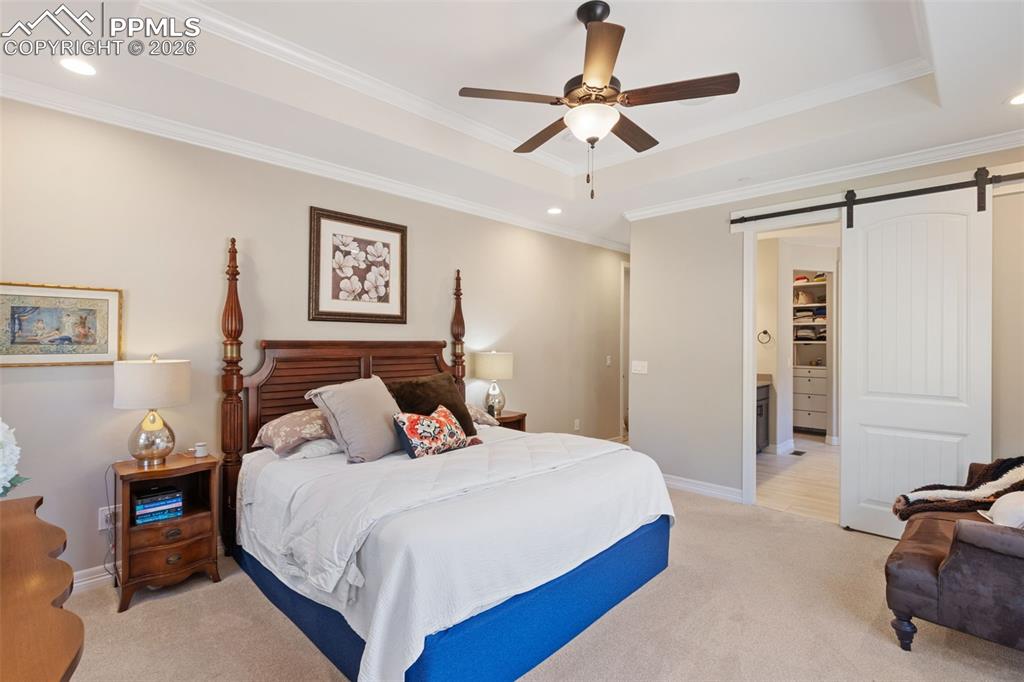 Image 18 of 49:  A sliding barn door provides a stylish, space-saving transition from the p