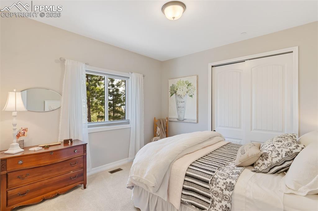 Image 22 of 49: The first guest suite provides a luminous, welcoming environment with gener