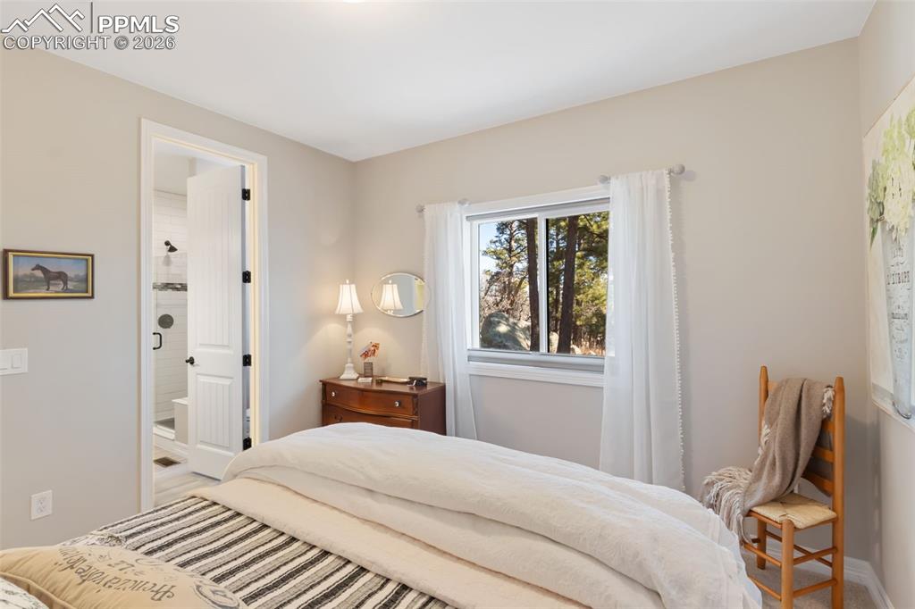 Image 23 of 49: Positioned with immediate access to an adjacent full bathroom, this bedroom