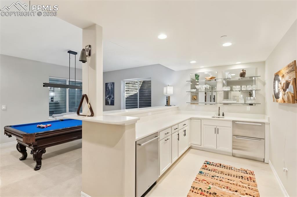 Image 28 of 49: The fully equipped wet bar, complete with a dishwasher, beverage center, an