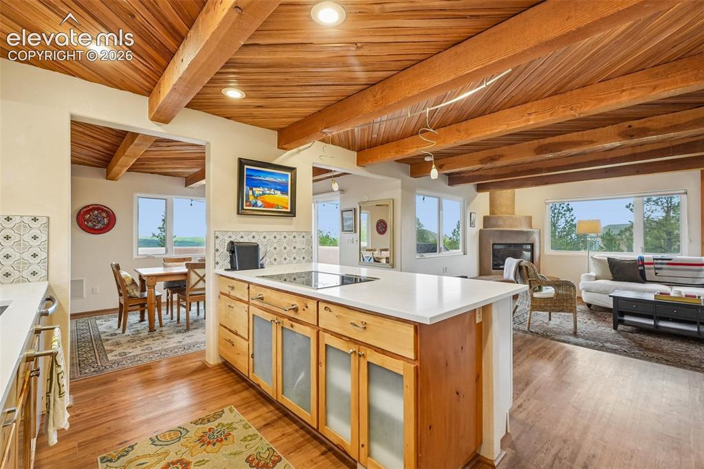 Image 10 of 50: Kitchen with quartz countertops, tile backsplash, a large island, ample cab