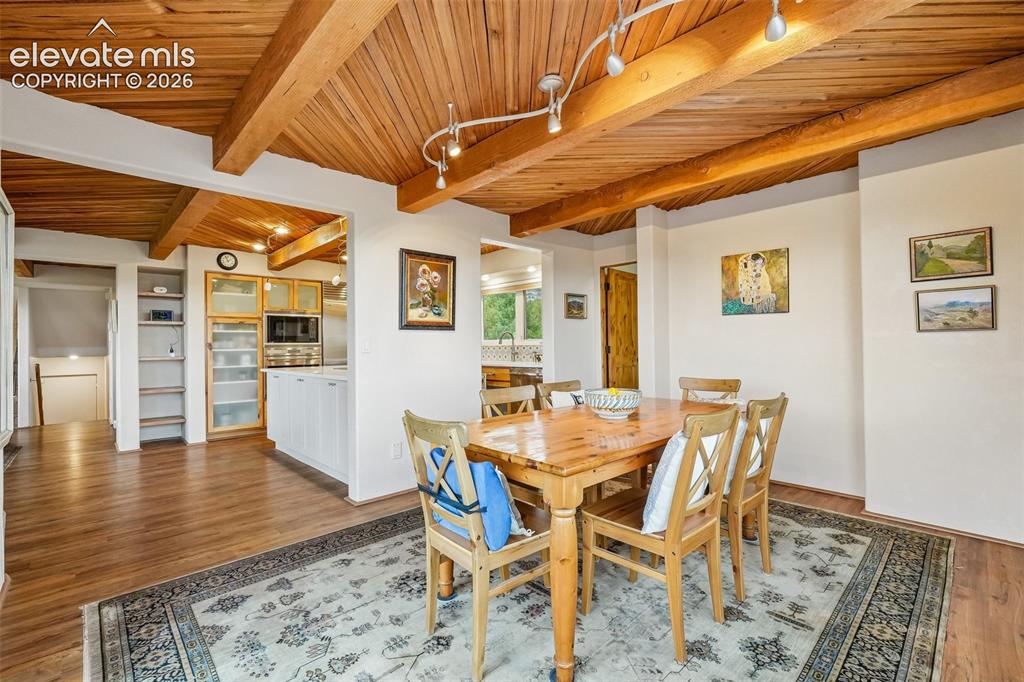 Image 11 of 50: Kitchen with quartz countertops, tile backsplash, a large island, ample cab