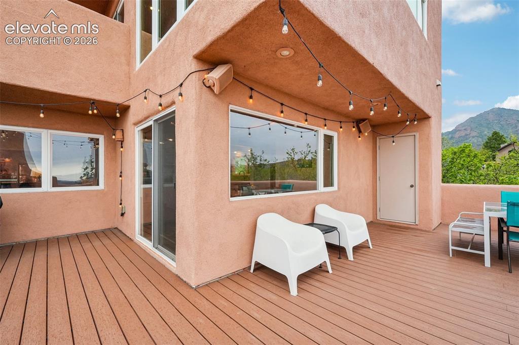 Image 14 of 50: Dining room with wood beamed ceilings, LVP flooring and a walk out to a spa