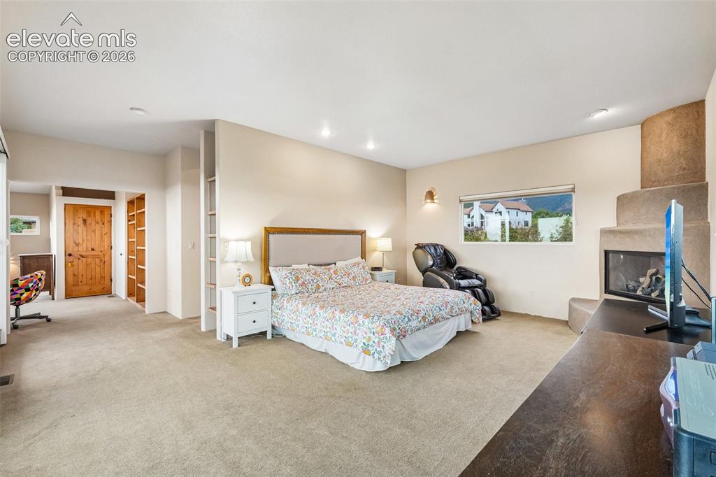 Image 18 of 50: Walk out deck off dining room with a kiva fireplace and views of the mounta